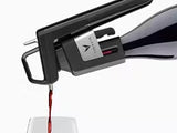 Wine being poured from a sleek black wine dispenser into a clear glass, showcasing rich red color.