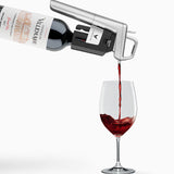 Red wine being poured from a bottle into a wine glass, featuring the label "Château de Villemajou."