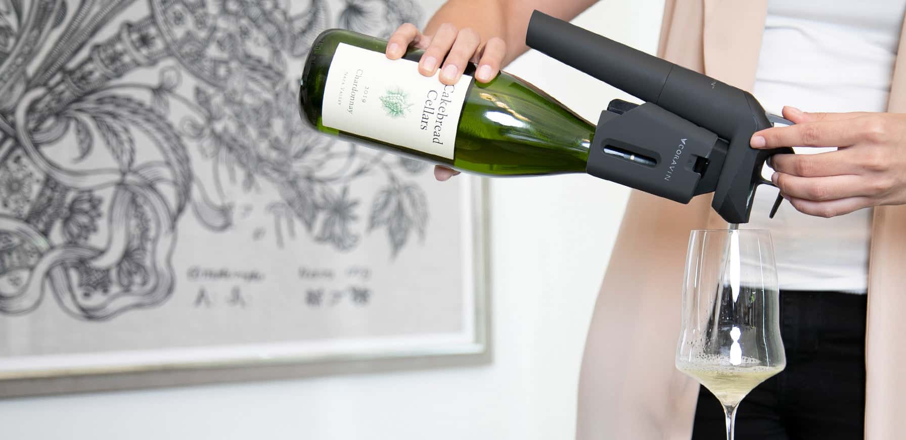 Pouring Cakebread Cellars Chardonnay using the Coravin Timeless wine preservation system into a white wine glass, demonstrating fine wine access without cork removal.