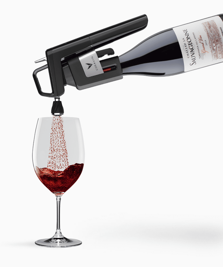 A wine bottle connected to a pouring device, dispensing red wine into a glass, creating a foamy effect.
