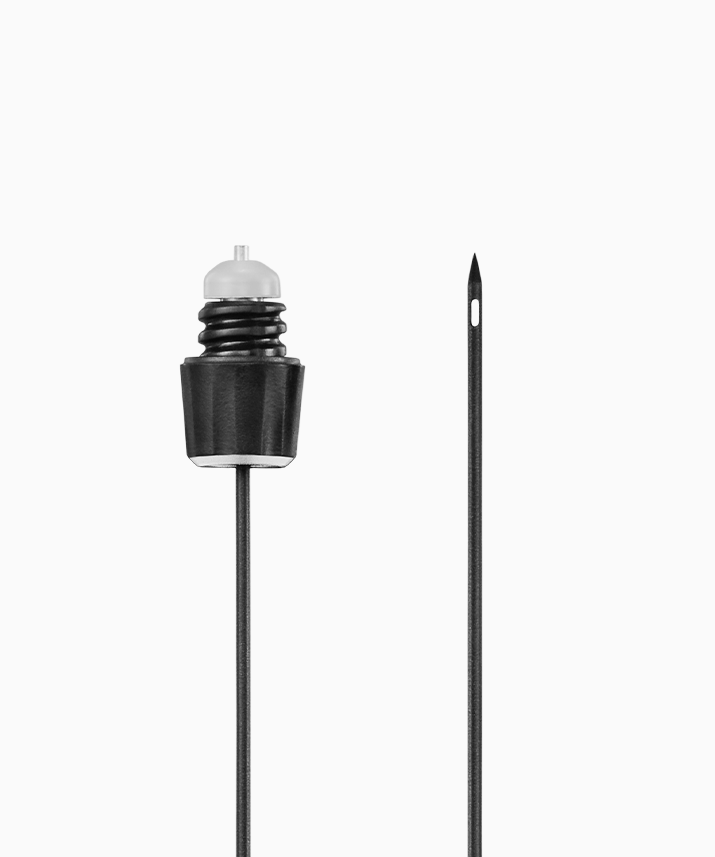Black Coravin needle tip with a transparent plunger and a long needle alongside, both designed for precision application.