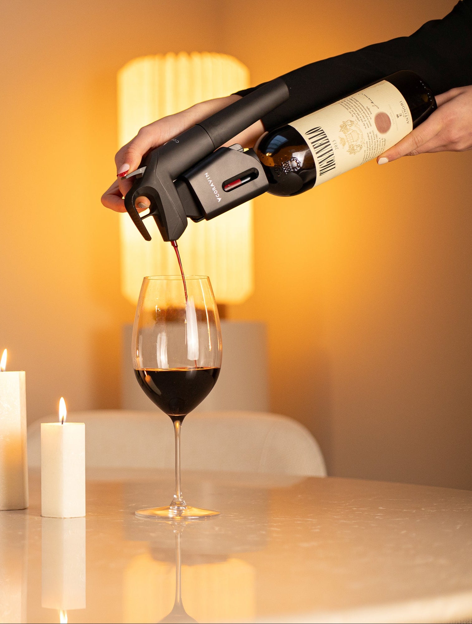 Pouring red wine using Coravin Timeless Six+™ wine by-the-glass system at home without removing the cork—perfect for wine lovers who savor wine anytime.